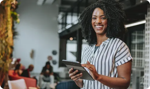Smiling woman using tablet.